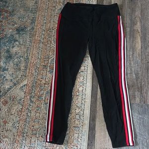 Black leggings with red and white stripes